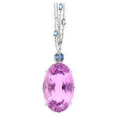 98.66 carat Kunzite and Aquamarine Pendant, an Art Deco masterpiece in 18K White Gold weighing 10.10 grams. This 21-inch pendant features an oval-cut Kunzite (36 x 22.2 MM) in a prong setting, emitting a captivating pink hue. Surrounding the Kunzite are eight Aquamarine stones (4.17CTTW, 7mm each), along with six more Aqua stones (1.09CTTW, 5 x 3 MM each). The ensemble is adorned with 37 round-cut Diamonds (0.36CTTW, 2mm - 1mm). Meticulously crafted, the pendant measures 4.75 cm, embodying moder Aqua Stone, Pink Kunzite, Aquamarine Pendant, Aquamarine Stone, Deco Jewelry, Metal Necklaces, High Jewelry, Round Cut Diamond, Diamond Pendant