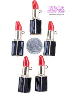 six red and black lipstick charms on a white background next to a quarter dollar coin