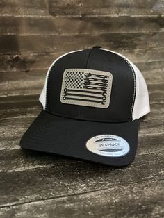 This is a custom made leather patch Hat! These are made to order. Hat brand is Yupoong 6606 ! Trucker style Hat with a SnapBack design. Black front- White mesh backing. Custom Tool Flag patch design ! Leather Patches are bonded to all hats **not stitched on** We use a powerful leather bonding and heat pressed for maximum bonding to the hat . If you want a specific brand of hat or color feel free to message me I do all types of hats ! Western Trucker Hat With Leather Patch, Western Style Adjustable Trucker Hat With Leather Patch, Custom Black Snapback Hat With Curved Brim, Trucker Baseball Cap Adjustable And Made In Usa, Adjustable Trucker Baseball Cap Made In Usa, White Adjustable Leather Hat, Adjustable White Leather Hat, Country Style White Snapback Hat, Custom Black Snapback Hat With Flat Bill