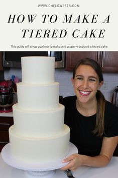 a woman standing next to a tall white cake on top of a table with the words how to make a tiered cake