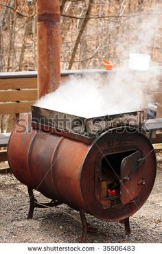 an old fashioned wood fired stove with steam coming out of it