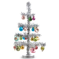 a silver christmas tree with ornaments on it