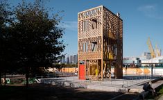 a tall wooden structure sitting in the middle of a park