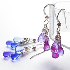 I was inspired to make these earrings by the varying pinks and lavenders of these tiny teardrops, transforming stained glass into elegant ombre earrings with just sunlight and gravity (and the help of a giant magnifying glass)! Every time you move your head and feel these earrings dance, you'll be reminded of the sunshine you're carrying with you - even indoors or on the stormiest day. Earring length: 1 3/8" Sterling silver findings are nickel-free and hypoallergenic Eco-friendly Lightweight and comfortable to wear Handcrafted in USA Sunshine in a drop of glass Each drop of glass is handmade in the artist’s backyard studio in Berkeley, California. Using a giant magnifying glass to focus sunshine, recycled bottles and stained glass were melted into these translucent, flowing drops under the Cheap Purple Glass Jewelry, Earrings Dance, Ombre Earrings, Backyard Studio, Berkeley California, Recycled Glass Bottles, Eco Friendly Jewelry, Recycled Bottles, Argentium Silver