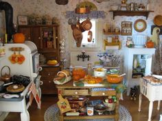 a kitchen filled with lots of clutter and cooking utensils on top of a wooden table