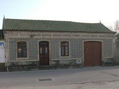 an old building with some doors and windows on the side of it's street