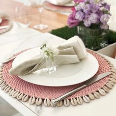 a place setting with white plates and silverware