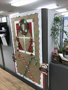 an office cubicle decorated for christmas with candy canes and decorations on the door