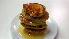 three pancakes stacked on top of each other with syrup drizzled over them