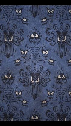 a blue and black wallpaper with an owl design on the front, surrounded by smaller owls