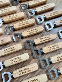 several pairs of wine openers with names and date engraved on them sitting on a table