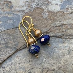 Stunning color combination! These drop earrings feature a faceted a lapis rondelle and a round gold pearl. The addition of sterling silver, vermeil and pyrite really set off the bold blue lapis. Ear wires are vermeil gold. Lapis: 10 x 6mm Pearls: 5mm Your jewelry will arrive in a cotton lined kraft box within a padded postal envelope. I use USPS first class mail. This usually takes 3 to 5 days to ship. International orders outside of the U.S. will take 8 to 15 days to ship. To see more from East Gold Lapis Lazuli Gemstone Earrings, Gold Lapis Lazuli Drop Earrings, Gold Lapis Lazuli Jewelry Set With Earrings, Nickel-free Gold Lapis Lazuli Earrings, Gold Lapis Lazuli Nickel-free Earrings, Gold Teardrop Lapis Lazuli Earrings, Gold Lapis Lazuli Earrings As Gift, Gold Lapis Lazuli Earrings For Gift, Jewelry 2024