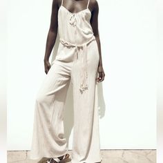 Brand New With Tag Size M Zara Sold Out Style!!! Cream Wide Leg Flowy Jumpsuit With Macrame Belt Cute Comfy And Stylish Chic Beige Jumpsuits And Rompers For Beach, Chic Cream Jumpsuits And Rompers For Vacation, Chic Beige Jumpsuit For The Beach, Cream Jumpsuits And Rompers For Summer Beach, Summer Cream Jumpsuits And Rompers For Beach, Elegant Beige Jumpsuits And Rompers For Loungewear, Zara Jumpsuits And Rompers For Beach, Cream Jumpsuits And Rompers For Summer Loungewear, Zara Casual Beach Jumpsuits And Rompers