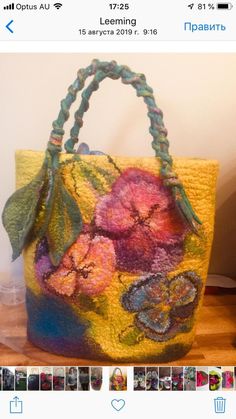 a bag with flowers painted on it sitting on a table