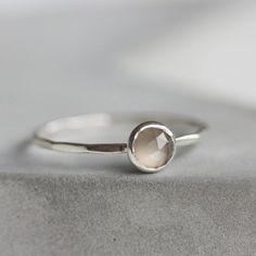 This refined silver ring with Gray Moonstone is a wonderful piece for a unique one. It is deep and mysterious, making up a perfect addition to your outfit.The ring is 1 mm thick and is very sturdy although it looks very dainty on the finger. The stone is 5 mm in diameter, rose cut.Choose the  material for the ring (sterling silver or 9k gold).You can order a ring of any size. If you are not sure about your size, this might be helpful: findmyringsize.comIf you want to buy the ring as a gift and y Silver Moonstone Stackable Rings With Birthstone, Delicate Silver Moonstone Ring For Gift, Silver Moonstone Stackable Rings, Minimalist Silver Moonstone Ring In Sterling Silver, Silver Minimalist Stackable Rings With Bezel Setting, Silver Stackable Rings With Bezel Setting, Delicate Sterling Silver Moonstone Ring, Dainty Silver Solitaire Moonstone Ring, Dainty Silver Moonstone Ring With Bezel Setting