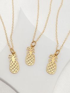 Our gift to you 10% off your first purchase. Details here - http:/eepurl.com/dpVPBz The pineapple is a symbol of welcome, friendship and hospitality. Our pineapple necklace is so dainty and flows freely on our signature sparkly chain. A meaningful addition to your jewelry collection. DETAILS 14 k fill chain and components Pineapple charm 24k gold over sterling silver Matte finish Very tiny stamp on back Charm is approximately 19 x 6 mm including jump ring This listing is for one necklace only No Tropical Necklace, Tiny Pearl Necklace, Fruit Fashion, Pineapple Jewelry, Fun Fruit, Interlocking Circle Necklace, Fruit Necklace, Pineapple Necklace, Fruit Jewelry