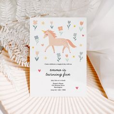 the unicorn is turning five birthday card has flowers and leaves on it, along with an envelope that says congratulations