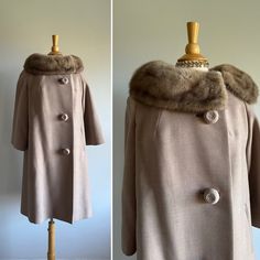 This elegant vintage coat features an understated finely woven wool; a matching luscious, face-framing collar that can be hooked close to fully wrap the neck; darling oversized top-stitched buttons; a swing shape; slightly bell sleeves; and an apricot satin lining. Two small repairs near wrist of sleeve (see photo). Pictured with room to spare on a US size 6/8 dress form.  Era: 1950s  Label: a Golet Original | blue and white ILGWU tag | Cohen's Sharon | RAS monogram | Pearl de Faille loomed for Brown Winter Wedding Outerwear, Winter Wedding Brown Outerwear, Elegant Winter Outerwear For Vintage Fashion, Elegant Vintage Winter Outerwear, Elegant Fitted Taupe Outerwear, Vintage Winter Wedding Outerwear, 1950s Fitted Winter Outerwear, 1950s Style Fitted Winter Outerwear, Oversized Top