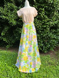 Beautiful watercolor floral print maxi skirt from the 1970s. Features yellow, blue, and pink flowers accompanied by green leaves on a white background. Simple floor-length / maxi silhouette. There is no brand label or size label. This piece may have been homemade. It closes with a plastic zipper topped with a metal hook and eye clasp. Perfect for spring and summer! Measurements Waist: 26 inches Length: 42 inches Condition: Excellent vintage condition. No flaws to note. If you have any questions or need additional photos or measurements, please let me know. I'm happy to help! Thank you so much for shopping with Chloris Vintage. --Chandler Yellow Maxi Skirt For Spring, Green Floral Print Maxi Skirt, Floral Print Maxi Skirt For Spring Garden Party, Spring Floral Print Yellow Maxi Skirt, Spring Yellow Floral Print Maxi Skirt, Retro Spring Flowy Maxi Skirt, Yellow Floral Print Maxi Skirt For Spring, Retro Flowy Maxi Skirt For Spring, Spring Retro Full Maxi Skirt