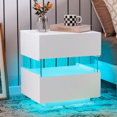 a white nightstand with blue light under it