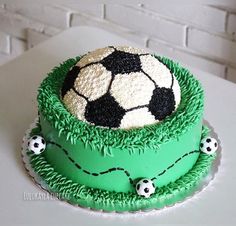 a soccer themed cake with green grass and white frosting