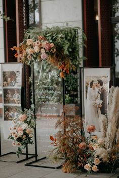 an arrangement of flowers and pictures on display