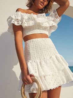 Make a statement with the Suri Two Pieces Set! This stylish set features delicate embroidery and flirty ruffle details, perfect for showing off your unique style. The off-shoulder neckline and high-rise design add a touch of femininity, while the cotton material ensures comfort. The crop top and short skirt length make it a versatile ensemble for any occasion. Specs: Material: Cotton Summer French Style, White Dress Top, Boho Swimwear, Vest Crop Top, Delicate Embroidery, Muslim Outfits, White Long Sleeve Dress, Long Romper, Short Kimono