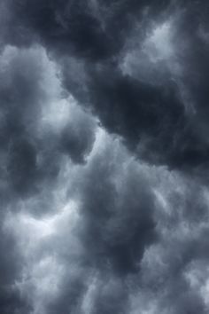 an airplane is flying in the cloudy sky