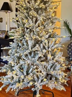 a white christmas tree with lights on it