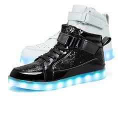 a pair of black and white shoes with blue lights