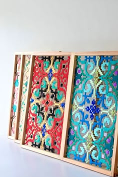 three wooden frames with different designs on them