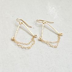 "These lovely gold filled chandelier earrings are made from 18g gold filled wire that's been hammered for a slight glimmer. It has dainty gold filled chains dangling across. Measures approximately 1 1/2\" long and 1\" wide" Gold Teardrop Threader Earrings 14k Gold Filled, Gold Dainty Teardrop Earrings Nickel Free, Dainty Gold Teardrop Earrings Nickel Free, Gold Chandelier Dangle Earrings For Everyday, Delicate Gold Wire Wrapped Earrings, Gold Threader Earrings With Delicate Chain, Dainty Gold Teardrop Earrings In 14k Gold Filled, Dainty Gold Teardrop Dangle Earrings, Dainty Gold Earrings With Delicate Chain