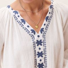 Our embroidered V neck top made of dreamy crinkle cotton crepe will be your go-to this summer! It's easy to wear, flows beautifully, and features lovely blue embroidery that gives it that extra something special. Dress it up or down all season long! Embroidered V-neck Peasant Top For Beach, Vacation V-neck Blouse With Embroidered Hem, Bohemian V-neck Embroidered Top With Chikankari, V-neck Blouse With Embroidered Hem For Vacation, Bohemian Embroidered Top With Chikankari And V-neck, Bohemian V-neck Chikankari Embroidered Top, Bohemian Chikankari Embroidered V-neck Top, Bohemian V-neck Top With Chikankari Embroidery, Beach V-neck Top With Embroidered Neckline