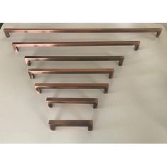 five metal shelfs are lined up on a white surface