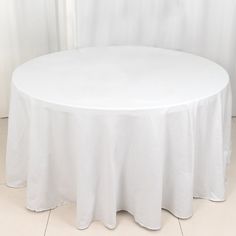 a round table with white cloth on it