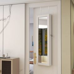 an open door leading to a bedroom with a mirror on the wall