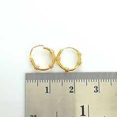 Bali style sterling silver ear hoops plated in real gold. Dimensions: 1.2 x 10 mm Price listed is for ONE PAIR of ear hoops. These are made of 925 hypoallergenic sterling silver plated with gold. Most of my pieces come with a 925 stamp. Can be packaged in a gift box. I can include a personal message from you if needed You are welcome to contact me at... bhavnakwintra1956@gmail.com For more beautiful pieces from my shop, please browse 👇 TOE RINGS: https://www.etsy.com/your/shops/TheSilverGame/to Handmade Small Hoop Gold Nose Rings, Handmade Gold Small Hoop Nose Rings, Wire Wrapped Yellow Gold Hoop Earrings, Handmade Gold Hoop Septum Ring, Handmade Gold Hoop Nose Rings, Minimalist Wire Wrapped Yellow Gold Hoop Earrings, Minimalist Yellow Gold Wire Wrapped Hoop Earrings, Nickel-free Small Hoop Gold Cartilage Earrings, Gold Nickel-free Small Hoop Cartilage Earrings