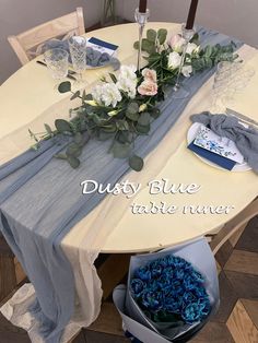 the table is set with blue and white flowers