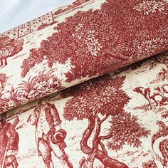 a red and white wallpaper with an image of people in the woods on it