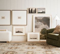 a living room filled with furniture and pictures on the wall next to a chair in front of a lamp