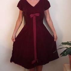 Vintage Abe Schrader Designer Retro Cranberry Red Velvet Cocktail Dress From The 50s, A-Line, Two Bow, Fitted Waist, Part Of The Hem Needs To Be Taped Back Up As Pictured. No Size But My Guess Is A 4, As That Is What I Wear. Red Dresses For Vintage Events, Red Vintage Dress For Vintage Events, Vintage Burgundy Dress For Evening, Burgundy Vintage Evening Dress, Vintage Burgundy Evening Dress, Red Retro Cocktail Dress, Retro Red Cocktail Dress, Red Knee-length Dress For Vintage Fashion, Red Velvet Cocktail