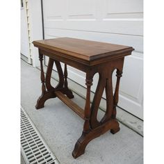 a wooden table sitting in front of a garage door