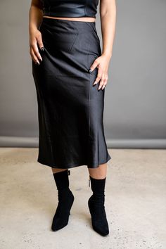 A slip skirt is a wardrobe must-have. This classic is the perfect wardrobe essential that can go from day to night depending on your vibe. Wear it with heels for the perfect date night look, or wear it with sneakers to transition it to the perfect errand skirt. FEATURES Zipper side closure Elastic waist Light stretch SIZE & FIT Model is wearing a size: Small. True to size. DETAILS 100% Polyester CARE Hand wash cold. Do not bleach. Line dry. Iron low. Stretch Midi-length Bottoms For Date Night, Stretch Midi Length Bottoms For Date Night, Spring Evening Stretch Pencil Skirt, Stretch Midi Skirt For Date Night, Flattering Black Skirt For Spring, Relaxed Flared Skirt For Date Night, Relaxed Fit Lined Skirt For Date Night, Trendy Solid Pencil Skirt For Night Out, Trendy Solid Color Pencil Skirt For Night Out