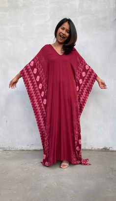 Indulge in the beauty of our classic kaftan with hand silk-screen printed fabric. This kaftan dress boasts unique patterns on high-quality rayon fabric. Its versatile design allows you to create many stylish looks, ensuring you always feel your best, whether you're at home or stepping out. Red Bohemian Kaftan With Ikat Print, Flowy Red Printed Kaftan, Traditional Printed V-neck Kaftan, Red Flowy Kaftan With Kimono Sleeves, Traditional Flowy V-neck Kaftan, Flowy Red Maxi Kaftan, Red Bohemian Maxi Dress With Batik Print, Traditional V-neck Block Print Kaftan, Red Bohemian V-neck Kaftan