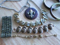 Retro vintage jewelry lot in gold tones, brass and shades of brown - perfect for the season! LERU signed thermoset leaf necklace, Trifari  cabochon bracelet, oversized wood chunky pendant circle necklace with big fleur de lis, slider charm bracelet (possibly Goldette?), 2 wood and etched brass stacking bangles and stretchy brass modernist bracelet.  All items are in good condition with minimal wear.  Don’t miss out on these great pieces of vintage jewelry! Antique Adjustable Brown Jewelry, Adjustable Antique Brown Jewelry, Brown Vintage Charm Jewelry As Gift, Brown Round Metal Jewelry, Vintage Adjustable Jewelry For Accessorizing, Adjustable Vintage Jewelry For Accessorizing, Unique Brown Metal Jewelry, Vintage Brown Metal Jewelry, Brown Adjustable Costume Jewelry