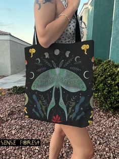 "Luna Moth mushroom Forest Tote Bag, Dark Cottagecore Tarot witch tote, Witchy large Polyester tote bag, boho hippies gift This practical, high-quality Tote Bag is available in three sizes. All over print provides comfort with style at the beach or out in town. Made from reliable materials, lasting for seasons. .: 100% Polyester .: Boxed corners .: Black cotton handles .: Black lining Size: S 13\"x13\" M 16\" x 16\" L. 19\"x19\" Ref:632 Sense Forest would like to provide some clarity regarding the creation of our designs. We take pride in crafting all our designs in our dedicated workshop located in Las Vegas, USA. For some of our products, we handle the printing in-house. However, for larger items that require specialized equipment, we collaborate with production partners both in the Unit Whimsical Handmade Bags For Everyday Use, Bohemian Handmade Canvas Bag For Gift, Bohemian Handmade Canvas Bag Gift, Handmade Bohemian Canvas Bag Gift, Bohemian Tote Canvas Bag As Gift, Bohemian Style Tote Canvas Bag As Gift, Bohemian Canvas Tote Bag As Gift, Bohemian Canvas Shoulder Bag Gift, Bohemian Canvas Shoulder Bag As Gift