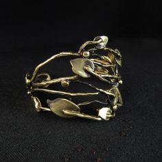 - Brass - Adjustable - Nickel Free, Hypoallergenic, Non Tarnish ----Planta Cuff---- Myri collection Handmade, hand forged, non tarnish adjustable Planta Cuff. Intricate organic design resembling leaves and branches. Colors: gold and black. - limited number  MATERIAL: Brass, Nickel Free & Hypoallergenic, Non Tarnish  SIZE: Adjustable Height Approx. 1.7″  =  45mm  SUGGESTED CARE: Use water and a drop of mild detergent. Rinse, then dry. Always make sure to wipe off water and dry your jewelry comple Vintage Gold Hand Cast Cuff Bracelet, Elegant Antique Gold Brass Cuff Bracelet, Hand Forged Metal Cuff Bracelet As Gift, Adjustable Cuff Bracelet With Lost Wax Casting For Gift, Bronze Wearable Art Cuff Bracelet As Gift, Bronze Hand Cast Cuff Bracelet Gift, Bronze Hand Forged Cuff Bracelet As Gift, Hand Cast Bronze Cuff Bracelet For Gift, Hand Cast Bronze Cuff Bracelet Gift