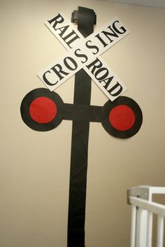 there is a cross on the wall with railroad crossing stickers in front of it