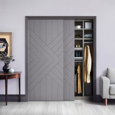 a living room with a couch, chair and open closet doors that have an arrow pattern painted on them