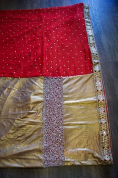 *Red with black and gold border and gold beading *Pleats of the saree is gold metallic material & the top half/pallu is red. *Material: Georgette & Lycra *Blouse Not Included *Color May Vary Slightly from picture *Our store is located in Los Angeles and in-store pick up is welcome *Returns not accepted *Single item available Festive Gold Pre-draped Saree With Resham Embroidery, Raw Silk Dupatta With Gold Embroidery For Festivals, Red Pre-draped Saree With Cutdana For Celebrations, Bollywood Style Gold Pre-draped Saree With Pallu, Bollywood Style Red Pre-draped Saree With Self Design, Unstitched Gold Chinon Blouse Piece, Gold Embroidered Chinon Saree, Chinon Saree With Gold Embroidery, Gold Chinon Blouse For Diwali